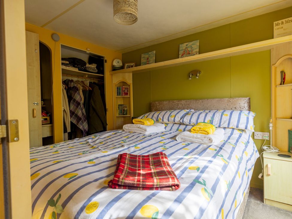 A bedroom with a bed and wardrobe at Coastal Hideaway in Cornwall Dog Friendly Goldsithney