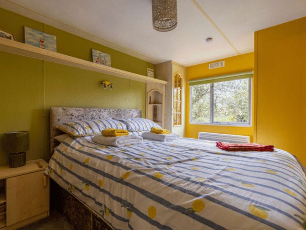 A bedroom with a bed and window at Coastal Hideaway in Cornwall Dog Friendly, Goldsithney