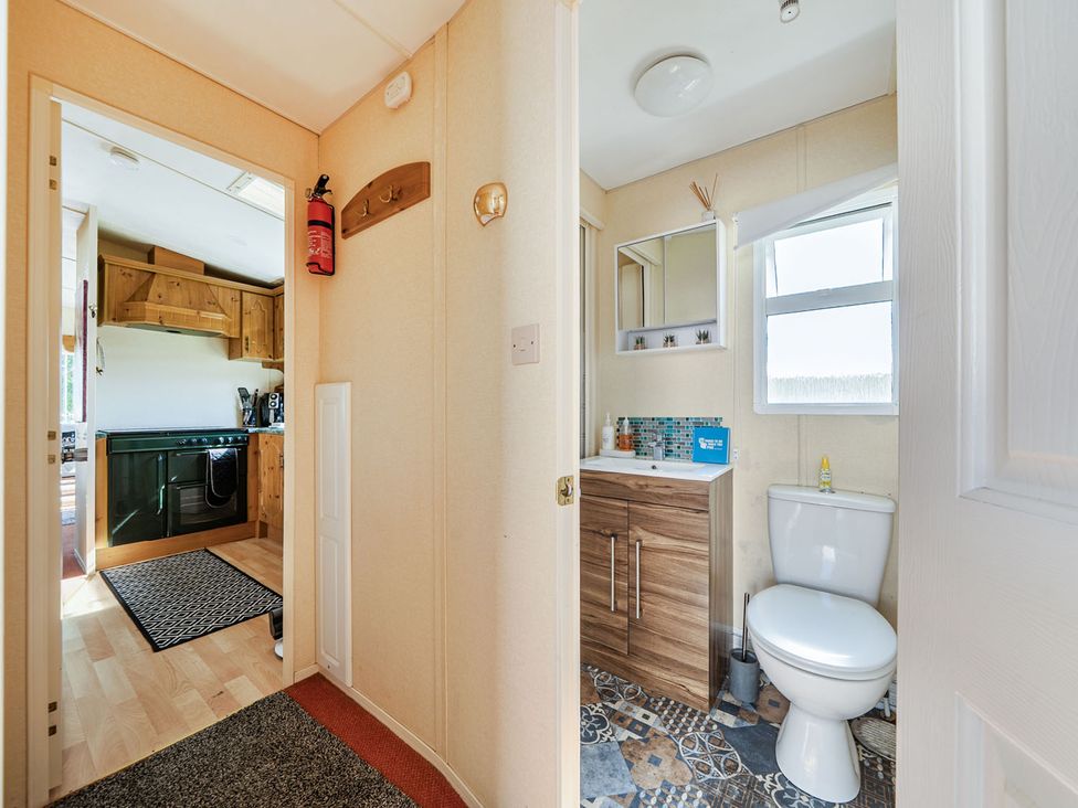 A bathroom with a sink and toilet at 3 Bed Sleeps 8 Sea View Pets Parking Reighton Gap near Filey