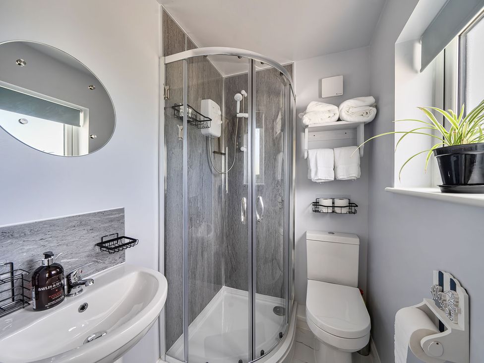 A bathroom with a shower, sink, and toilet at Studio Sleeps 2 with Parking and Garden, Trewidland near Liskeard