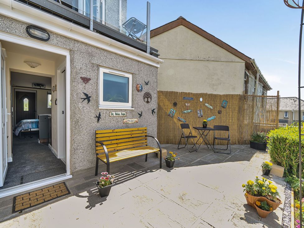 An outdoor seating area with a table and chairs at Studio Sleeps 2 with Parking and Garden Trewidland near Liskeard