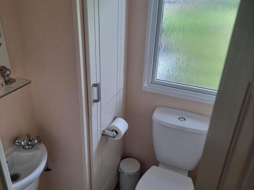 A bathroom with a sink and toilet at Chalet Sleeps 6 swimming pool Thorness Bay