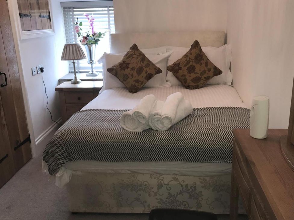A bedroom with a bed and side table at Barn Sleeps 4 Parking Near Alton Towers Waterhouses