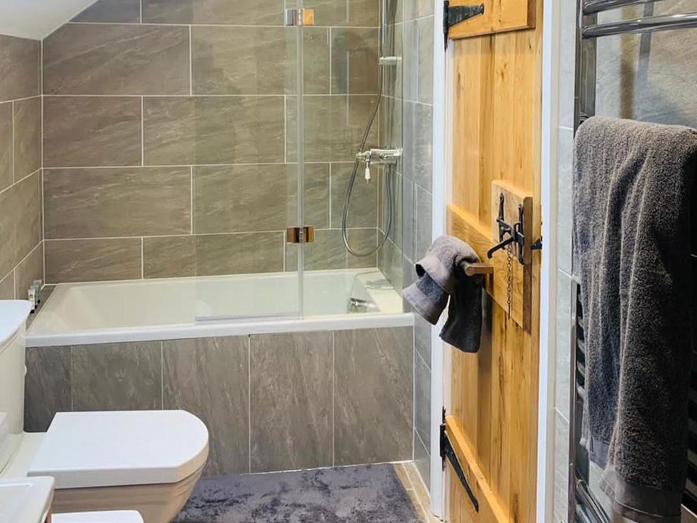 A bathroom with a bathtub and toilet at Barn Sleeps 4 Parking Near Alton Towers Waterhouses