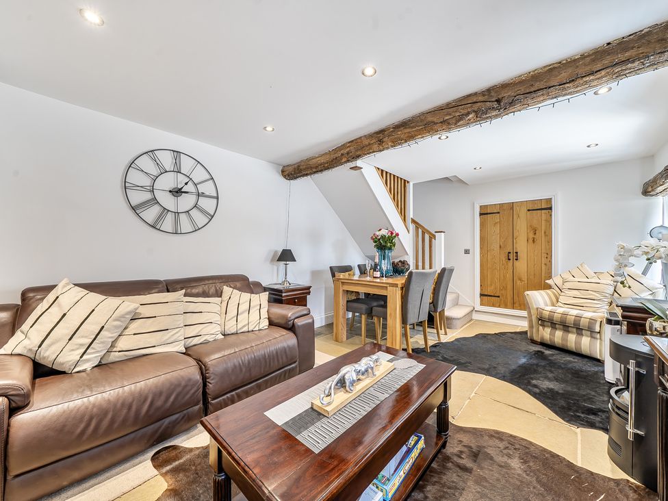 A living room with a sofa and dining table at Barn Sleeps 4 Parking Near Alton Towers Waterhouses