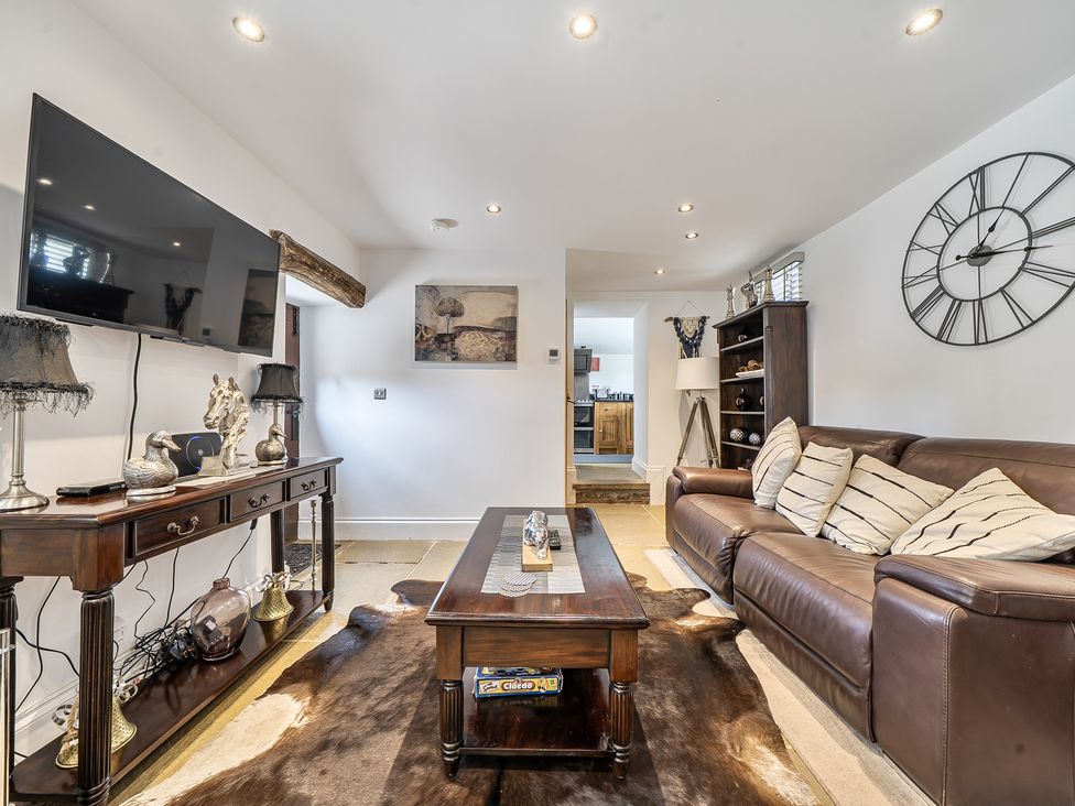 A living room with a television and a coffee table at Barn Sleeps 4 Parking Near Alton Towers Waterhouses