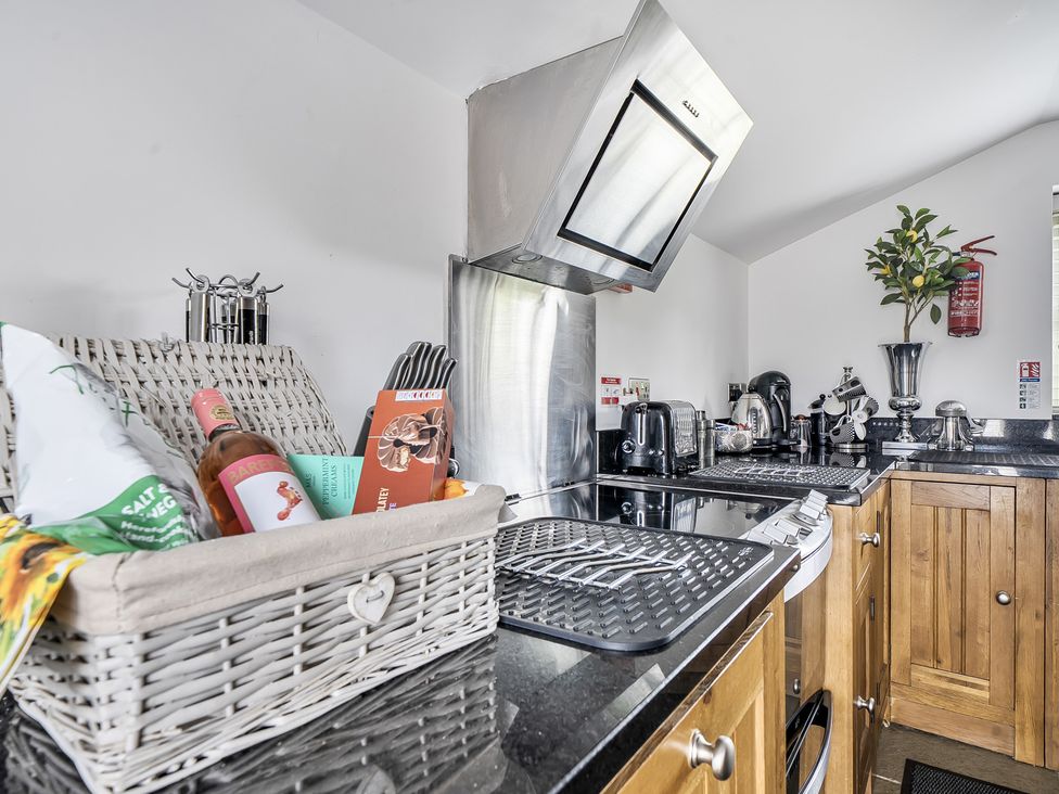 A kitchen with appliances and a basket at Barn Sleeps 4 Parking Near Alton Towers in Waterhouses