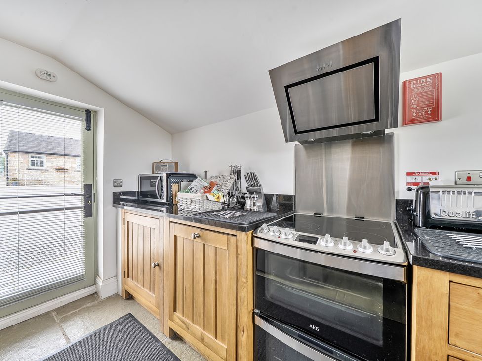 A kitchen with cabinets and appliances at Barn Sleeps 4 Parking Near Alton Towers Waterhouses