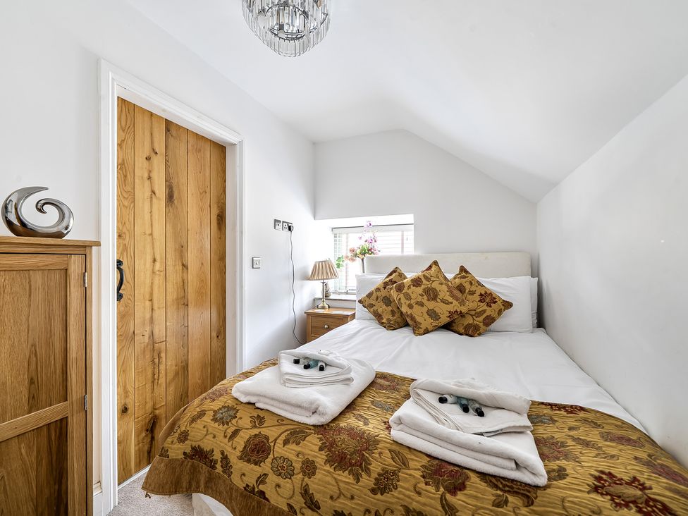 A bedroom with a bed and decorative pillows at Barn Sleeps 4 Parking Near Alton Towers Waterhouses