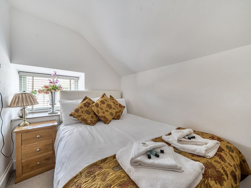 A bedroom with a bed, bedside table, and lamp at Barn Sleeps 4 Parking Near Alton Towers Waterhouses