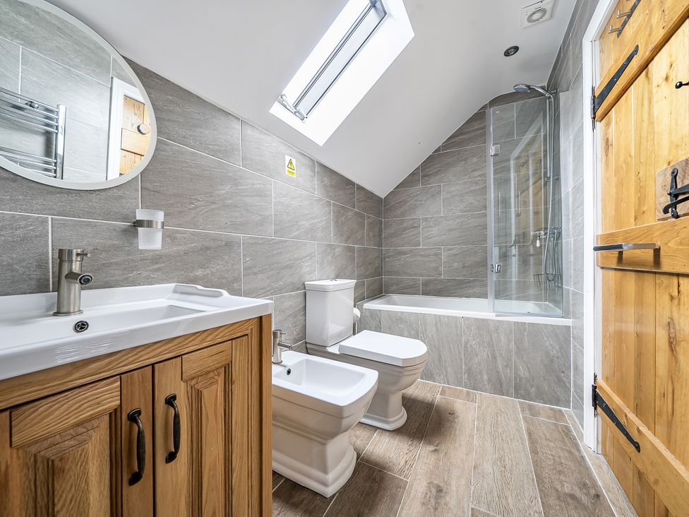 A bathroom featuring a sink, toilet, bidet, bathtub, and shower at Barn Sleeps 4 Parking Near Alton Towers Waterhouses