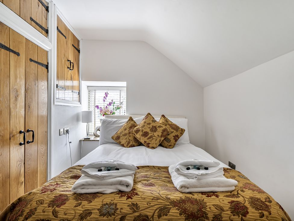 A bedroom with a bed and pillows at Barn Sleeps 4 Parking Near Alton Towers in Waterhouses