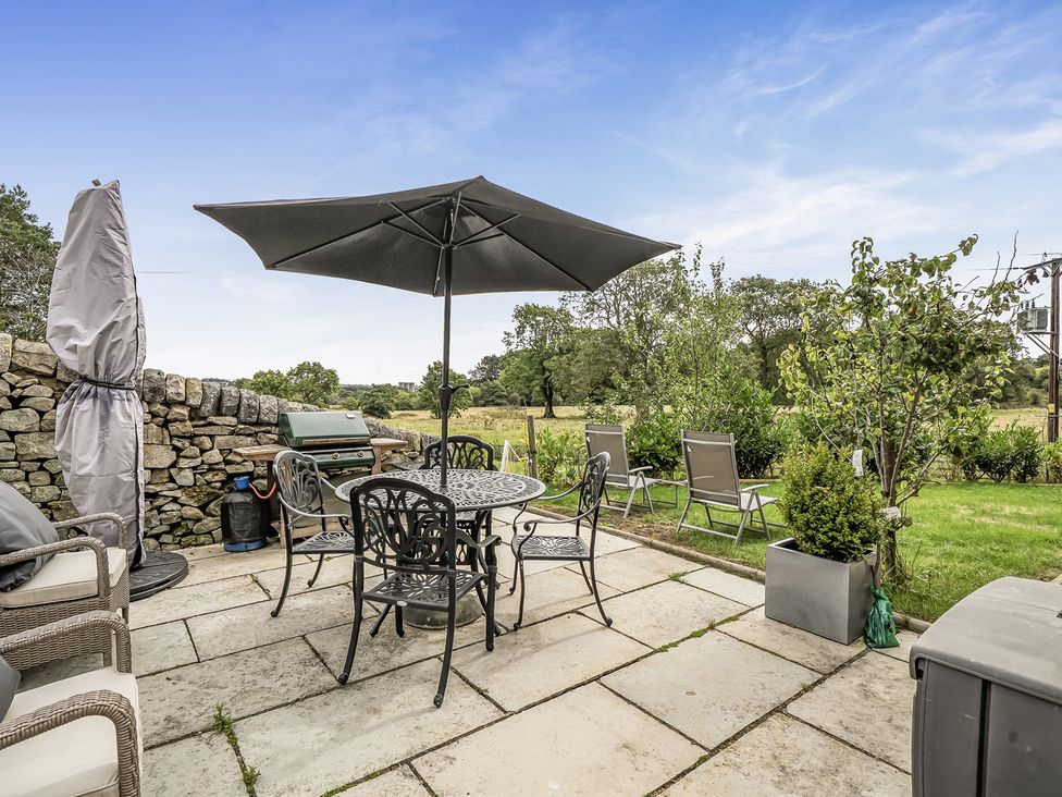 An outdoor seating area with a table and chairs at Barn Sleeps 4 Parking Near Alton Towers in Waterhouses