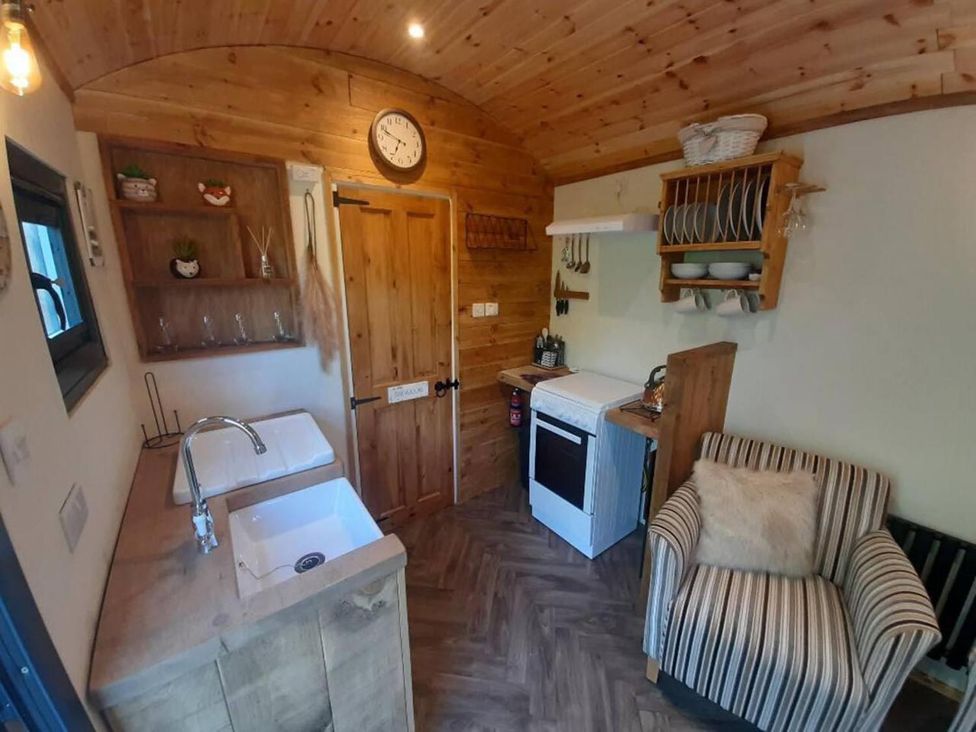 A kitchen with sink and stove at Min yr Afon Cabin Sleeps2 Hot Tub Parking in Gwalchmai