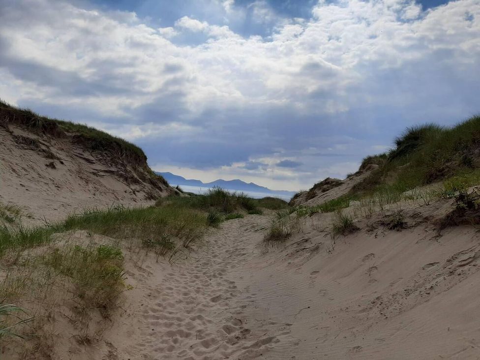 A pathway between sand dunes at Min yr Afon Cabin Sleeps2 Hot Tub Parking in Gwalchmai