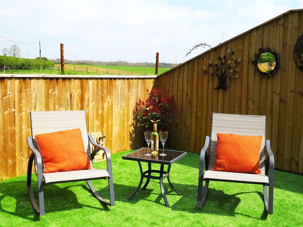 A seating area with chairs and a table at an outdoor space