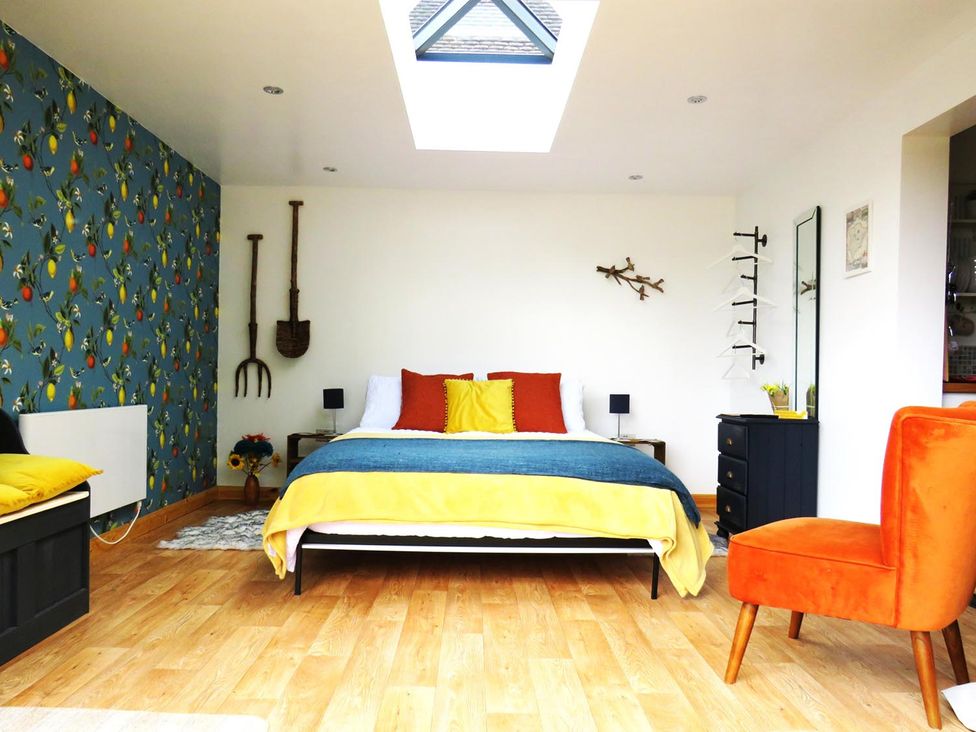 A bedroom with a bed and chair at the property
