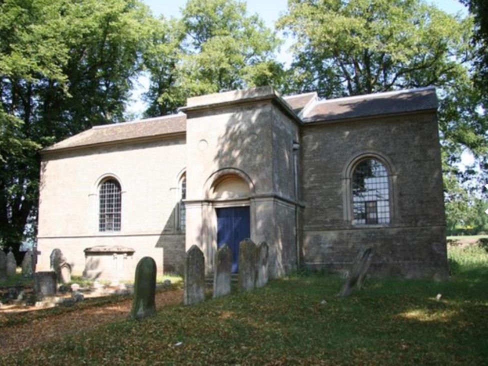 A church with gravestones in a cemetery