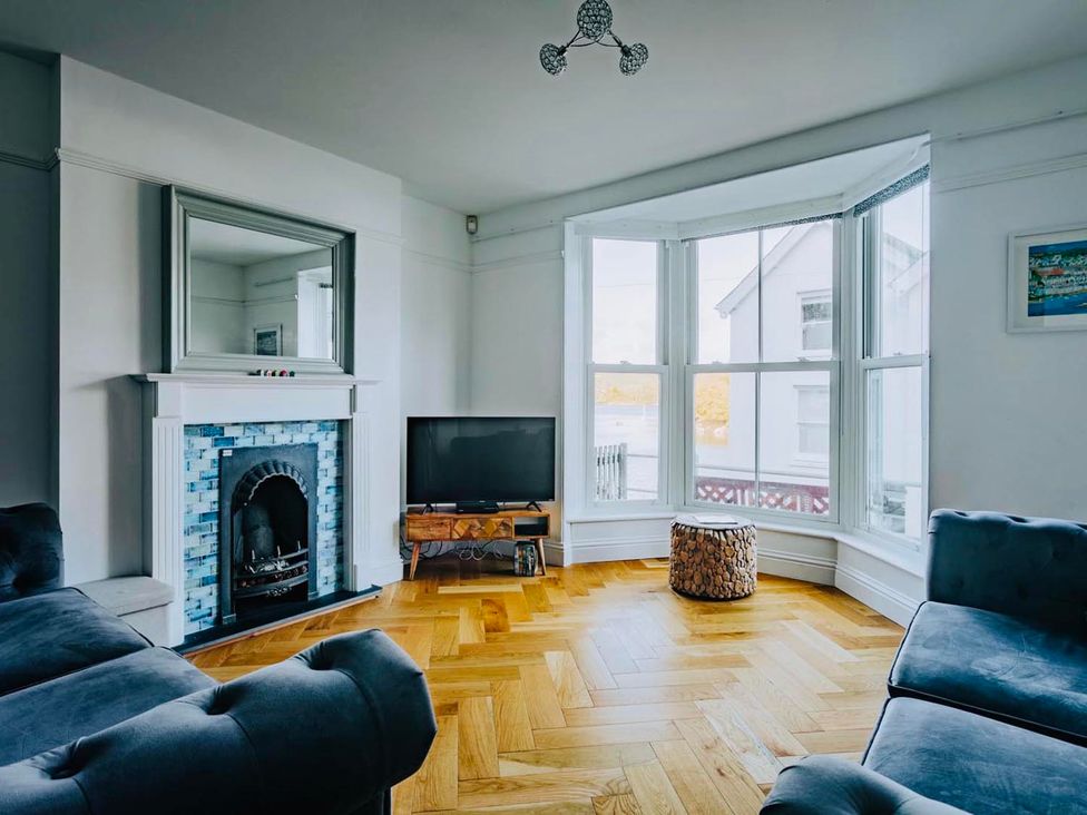 A living room with a fireplace and television at The Slipway Fowey Harbour with Garden in Fowey