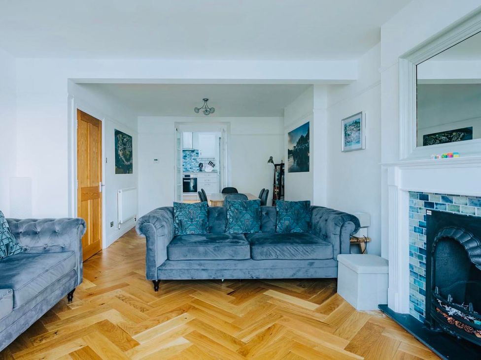 A living room with sofas and a fireplace at The Slipway Fowey Harbour with Garden in Fowey