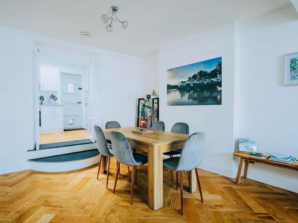 A dining room with a table and chairs at The Slipway Fowey Harbour with Garden in Fowey