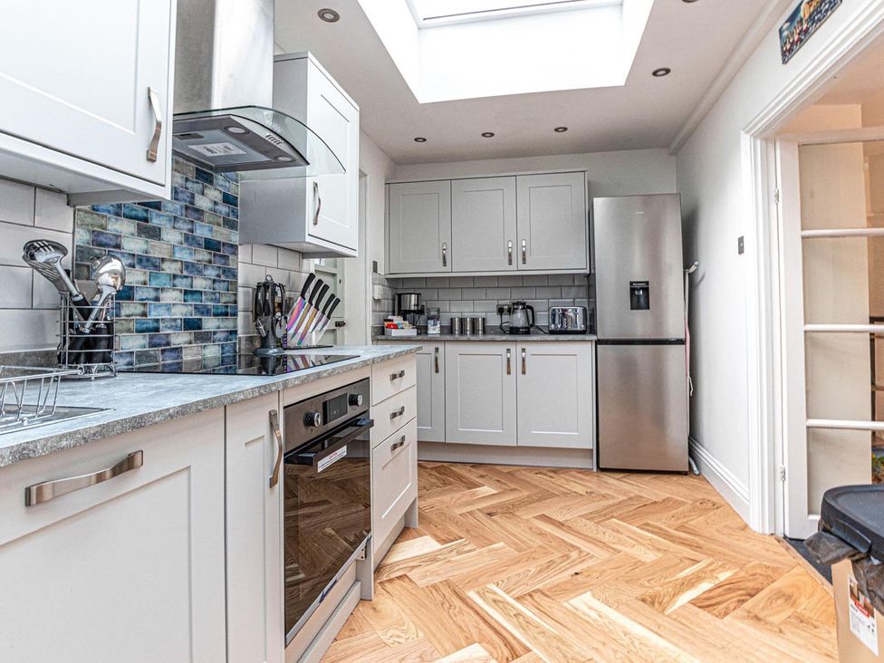 A kitchen with cabinets and appliances at The Slipway Fowey Harbour with Garden Fowey