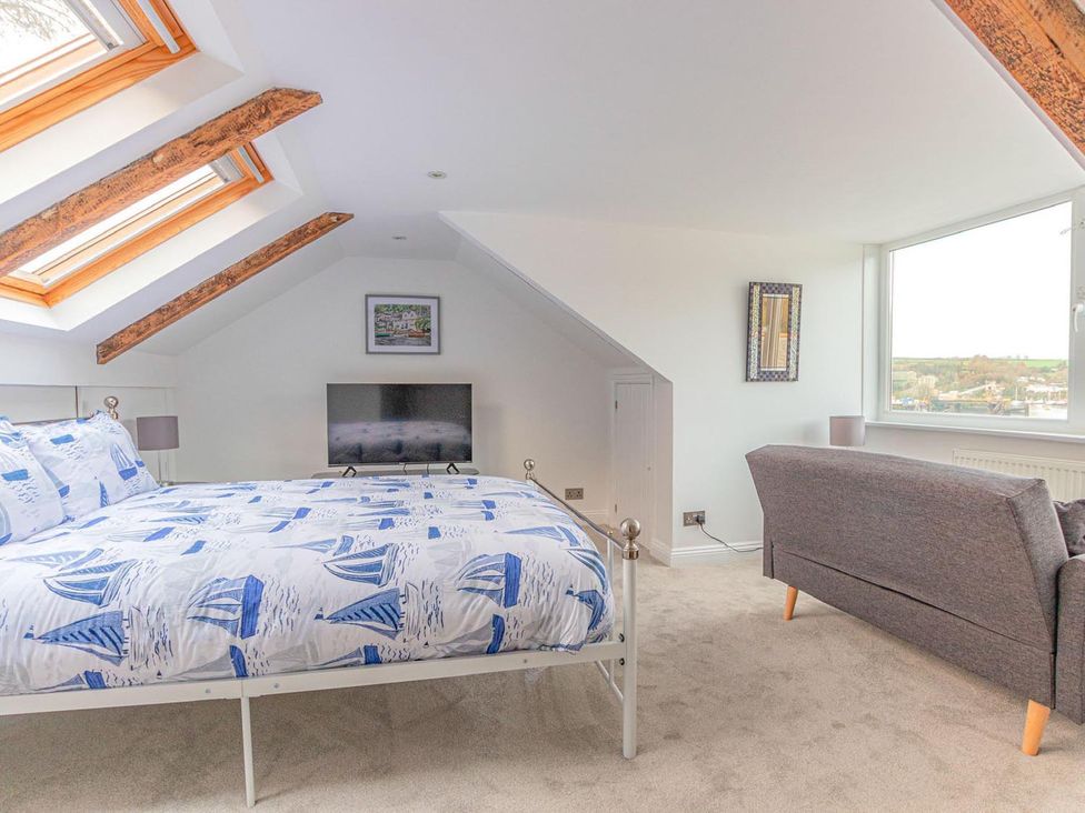 A bedroom with a bed and a tv at The Slipway Fowey Harbour with Garden in Fowey