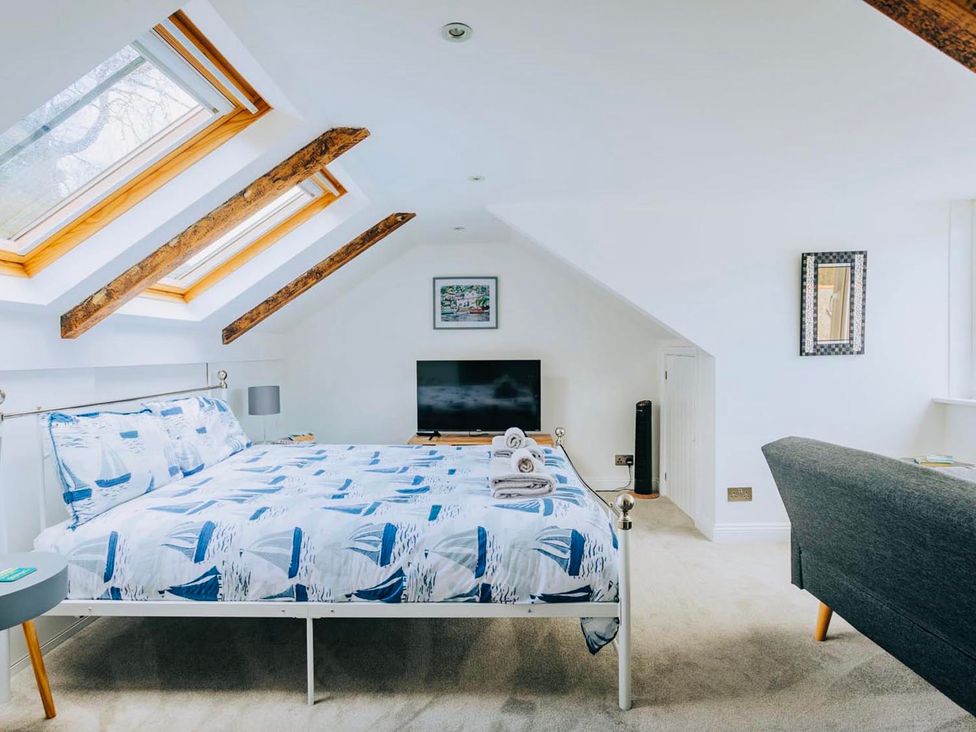 A bedroom with a bed and television at The Slipway Fowey Harbour with Garden Fowey