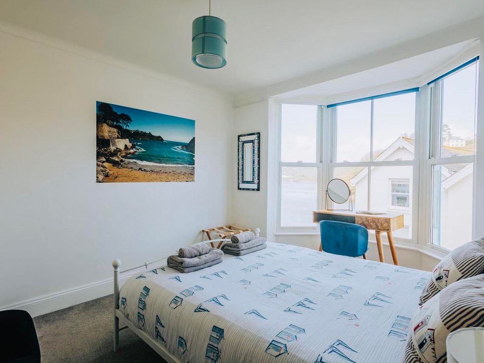 A bedroom with a bed and a mirror at The Slipway Fowey Harbour with Garden Fowey
