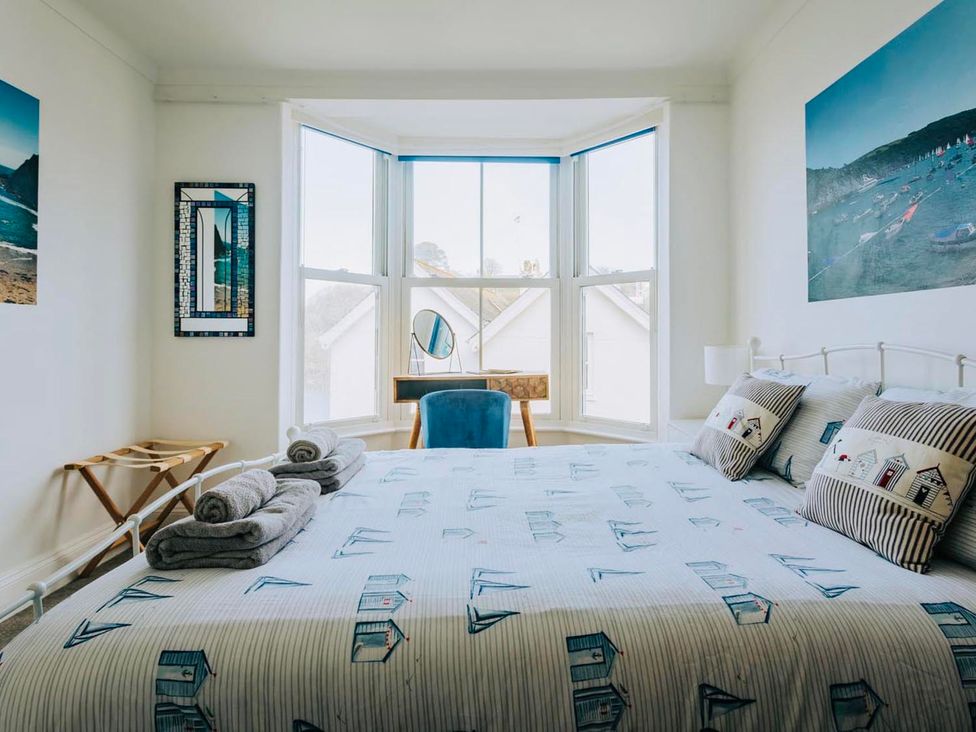 A bedroom with a bed and window at The Slipway Fowey Harbour with Garden Fowey