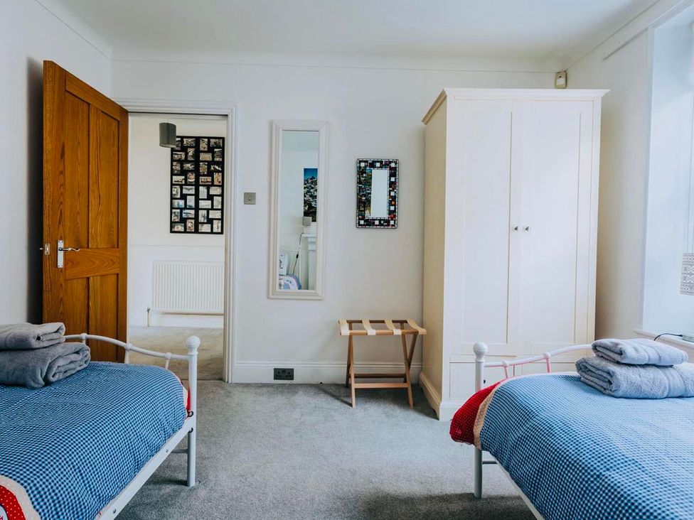 A bedroom with two beds and a wardrobe at The Slipway Fowey Harbour with Garden Fowey