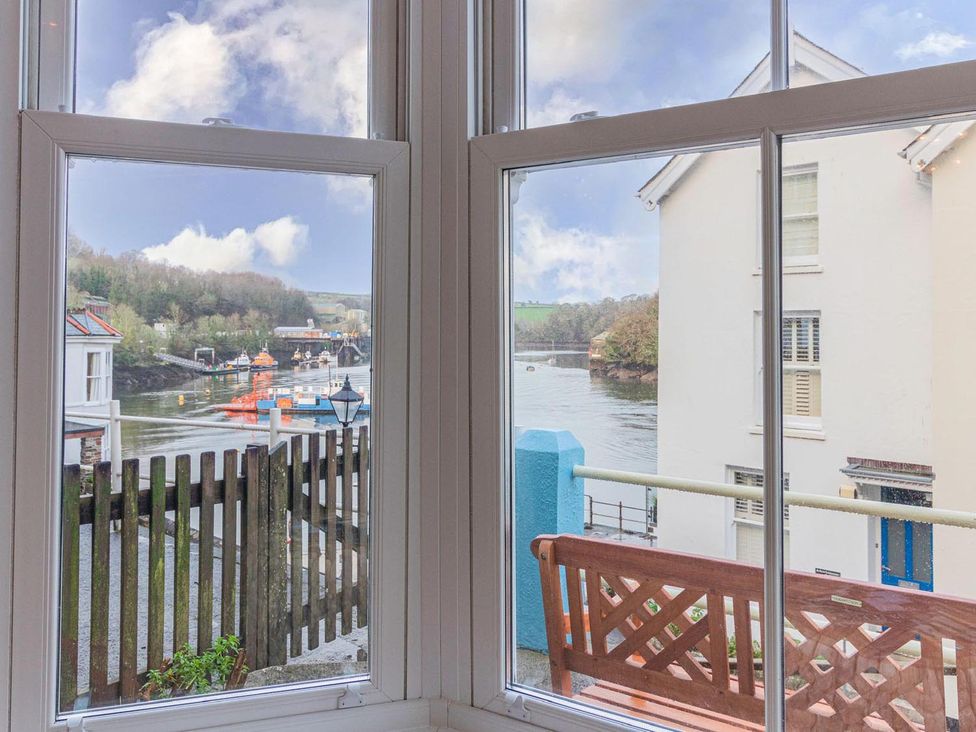 A view from a window showing a river and houses at The Slipway Fowey Harbour with Garden in Fowey