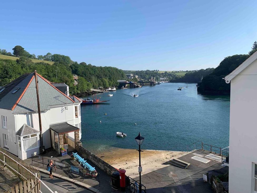 A house by the water with boats and a pier at The Slipway Fowey Harbour with Garden Fowey