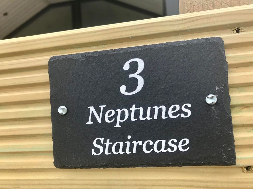 A sign displaying number 3 and the name Neptunes Staircase