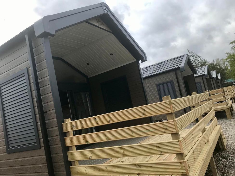 Lodges with wooden decking and shutters at Selfcatering Lodge Inverness Sleeps 4 Inverness