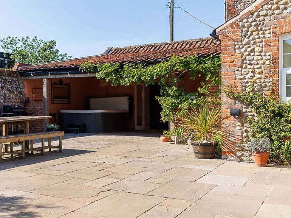 An outdoor area with paving stones and a hot tub at North Norfolk Garden Retreat with Private Hot Tub, Crossdale Street near Cromer