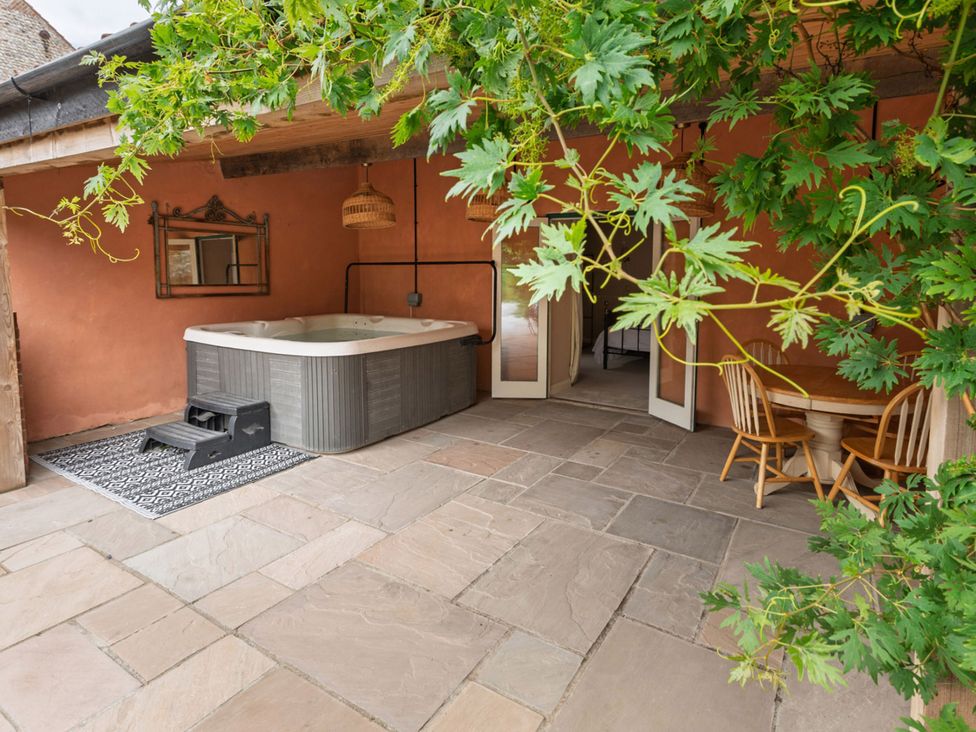 An outdoor area with a hot tub and seating at North Norfolk Garden Retreat with Private Hot Tub Crossdale Street near Cromer