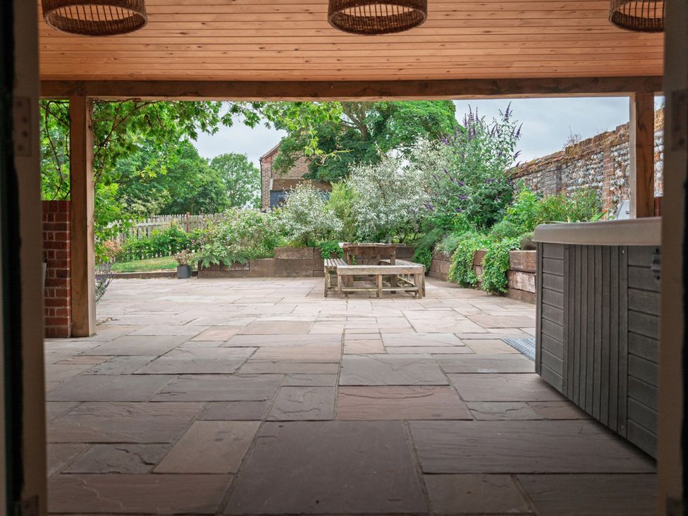 An outdoor area with a hot tub and seating at North Norfolk Garden Retreat with Private Hot Tub, Crossdale Street near Cromer