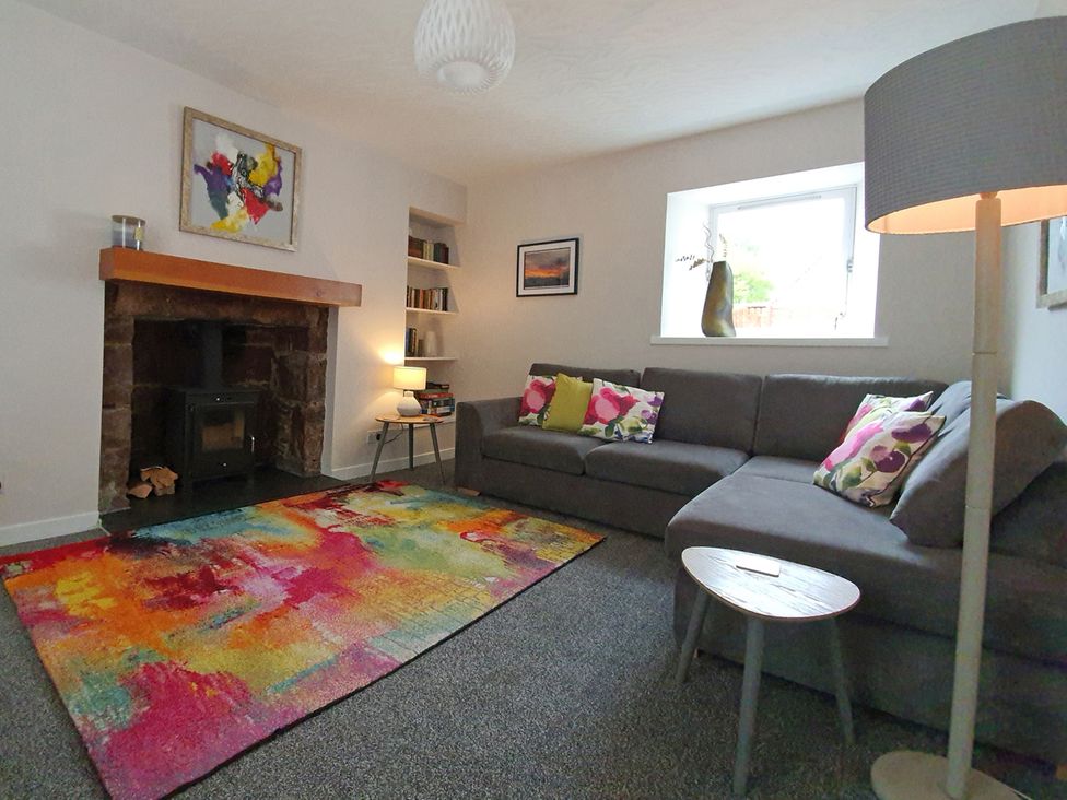 A living room with a sofa and fireplace at the property