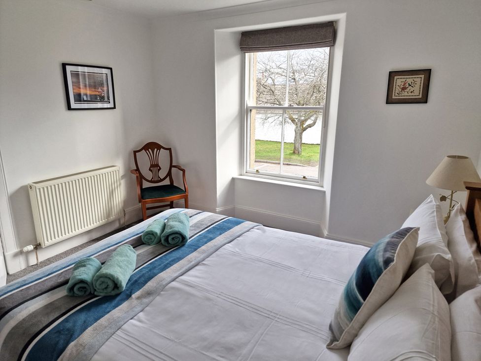 A bedroom with a bed and chair at the property in the location