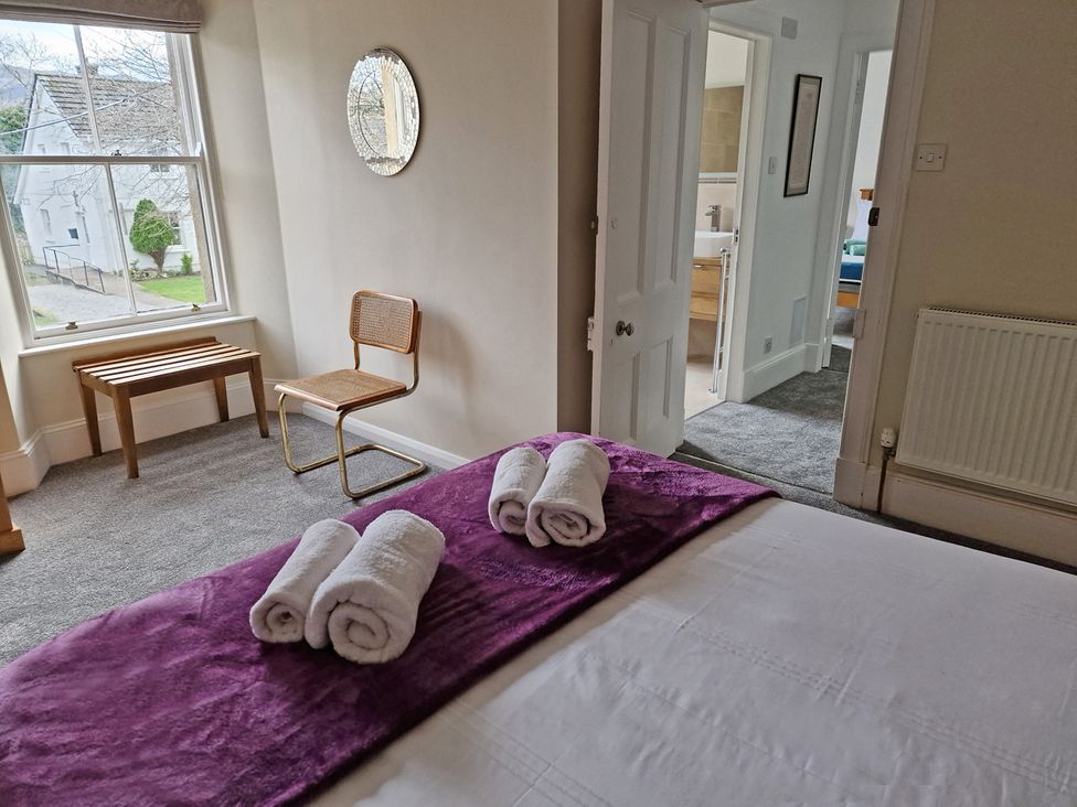 A bedroom with a bed and towels on it at The Old Barn in Manchester