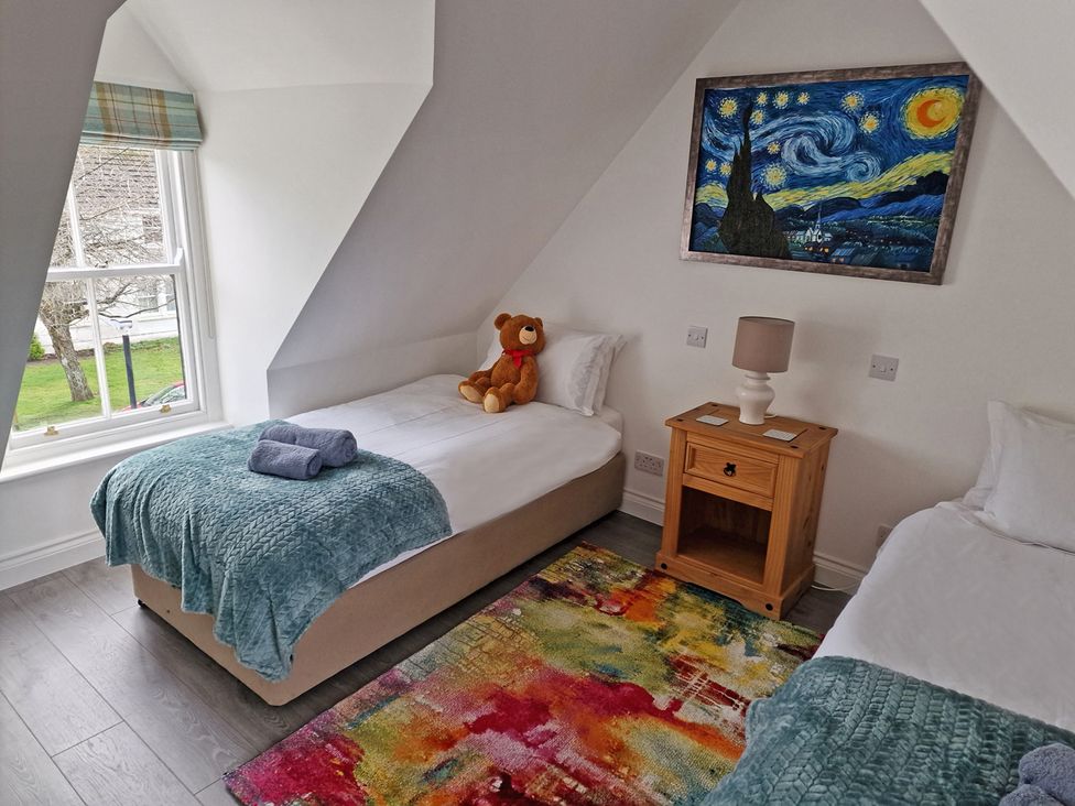 A bedroom with two beds and a teddy bear at the property in location