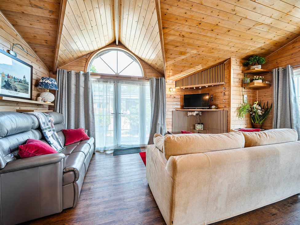 A living room with a sofa and television at Alpaca Farm Valley Views Sleeps 4 Parking Pets in Husthwaite