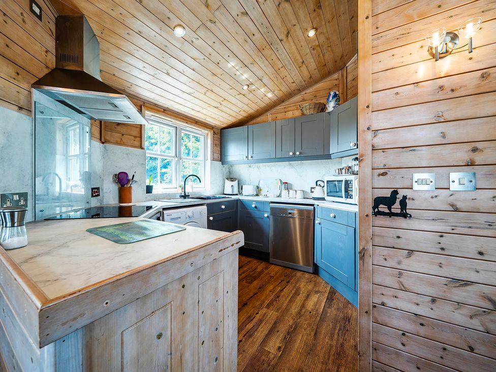 A kitchen with cabinets and appliances at Alpaca Farm Valley Views Sleeps 4 Parking Pets in Husthwaite