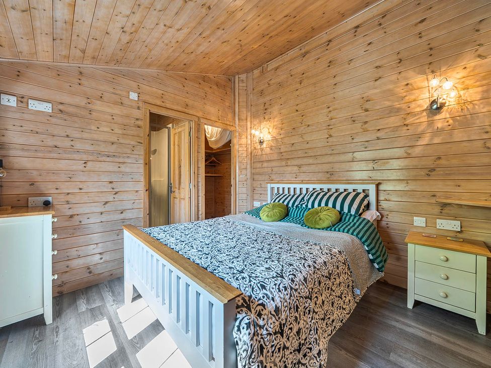 A bedroom with a bed and chest of drawers at Alpaca Farm Valley Views Sleeps 4 Parking Pets in Husthwaite