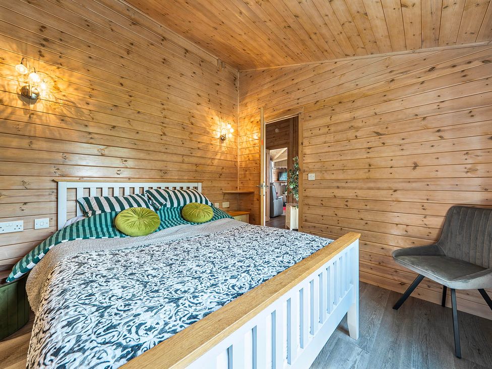 A bedroom with a bed and chair at Alpaca Farm Valley Views Sleeps 4 Parking Pets in Husthwaite