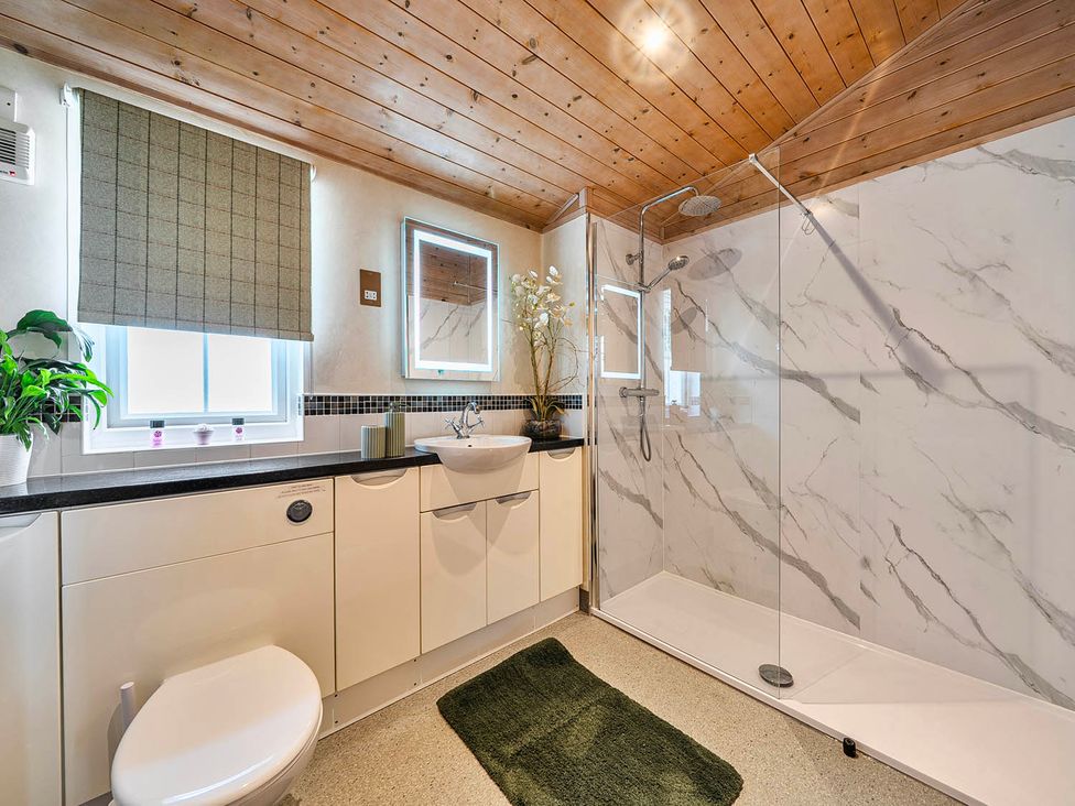 A bathroom with a shower and sink at Alpaca Farm Valley Views Sleeps 4 Parking Pets Husthwaite