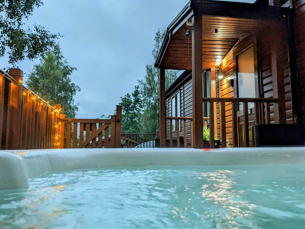 A hot tub on a wooden deck at Felmoor Park Northumberland Lodge with Hot Tub near Felton
