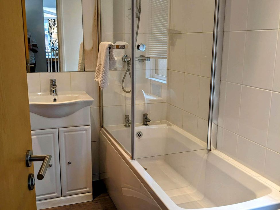 A bathroom with a bathtub and sink at Felmoor Park Northumberland Lodge with Hot Tub, Felmoor Park near Felton