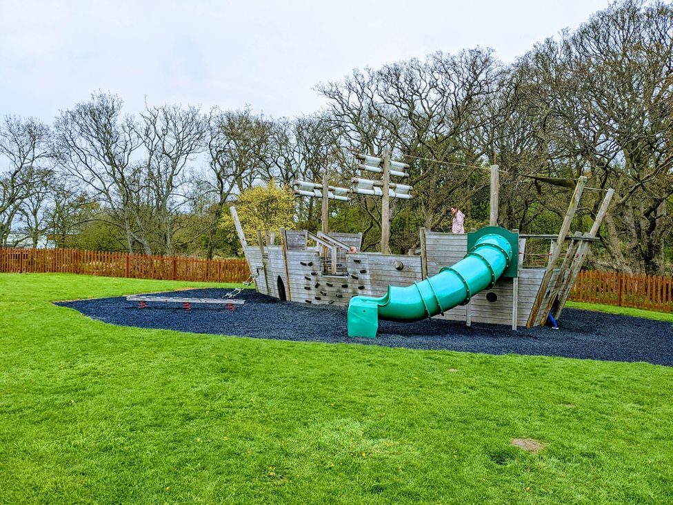 A playground with a pirate ship structure and slide at Felmoor Park near Felton